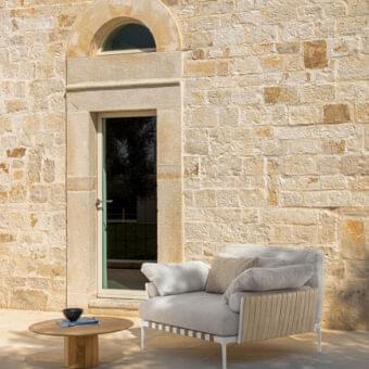 Distinctive Talenti Salinas lounge chair with light gray textile cushions and matte white metal frame built with light brown accents