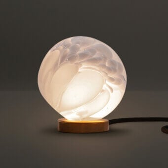 Sophisticated Bocci 118 table lamp with white opal glass shade and sleek brass cylinder housing a dimming system