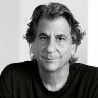 David Rockwell portrait, black and white photograph, architect and designer, studio lighting, relaxed expression, graying dark hair.