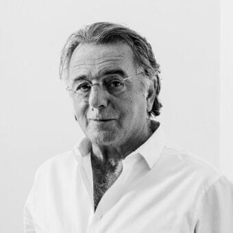 Gray scale portrait of a mature man with graying hair and glasses looking slightly to his right