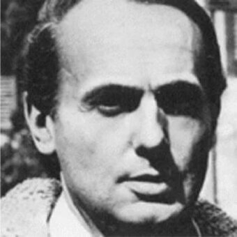 Monochrome portrait of a man with receding dark hair, shadowed eyes, and textured clothing partially visible in the frame