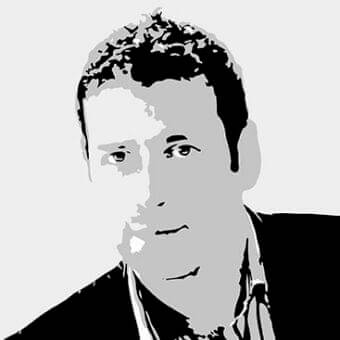 Grayscale portrait of a man from the chest up, facing forward with angled pose and limited tonal range