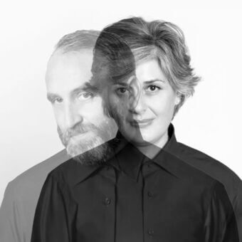 Black and white composite portrait of a man and woman, faces layered for blended effect, neutral expressions, plain white background.