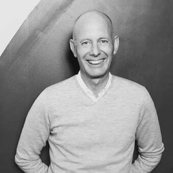 Ben Van Berkel portrait, gray sweater, corrugated metal architecture, curved structure, linear pattern, neutral background, diffused lighting.