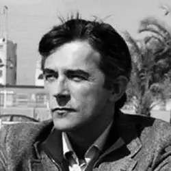 Cesare Monti portrait, black and white photograph, tweed jacket, serious expression, blurred outdoor background with architecture and vintage car.