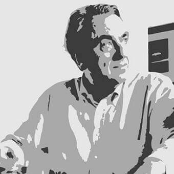 Grayscale portrait shows a shadowed face angled left with a dark rectangular shape below and to the right