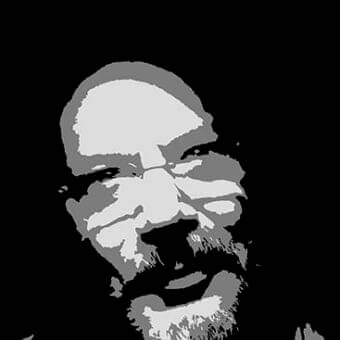 Stylized grayscale portrait of a man’s face with angular features and textured beard against a black background
