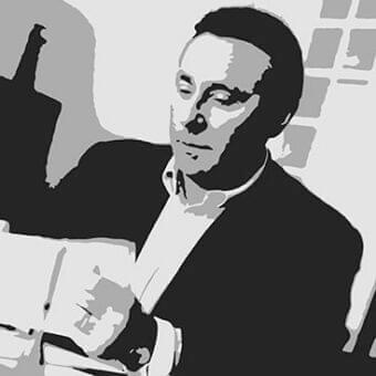 Man in suit holding papers with blurred shape and grid pattern in the background