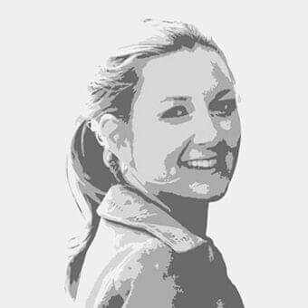 Grayscale face portrait shows a woman with swept hair and a slight smile, wearing a collared garment against a light gray backdrop