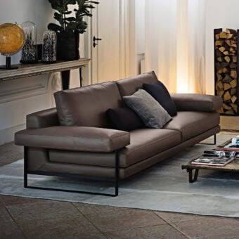 Exceptional Arketipo Ego sofa with carved geometric lines and smooth brown leather-like material, built with a black metal frame