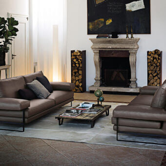 Elegant Arketipo Ego sofa with geometric lines and smooth brown leather upholstery supported by a sleek black metal frame