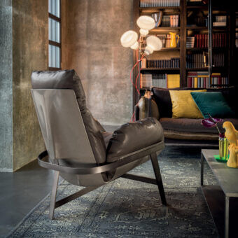 Architectural Arketipo Jupiter lounge chair with gray metal arch and gray-brown leather-like seat offering dynamic lightness