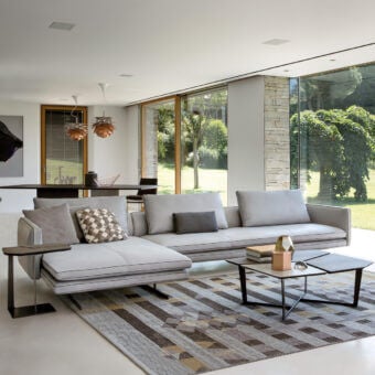 Distinguished Arketipo Moss sectional with light gray textile upholstery and dark metal base showcasing geometric forms with thin trim