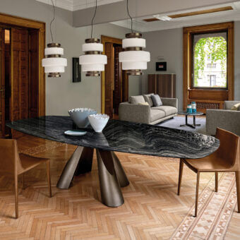 Superior Arketipo Prince table with shaped dark marble-like top and luxury metal base in muted bronze or gunmetal tone