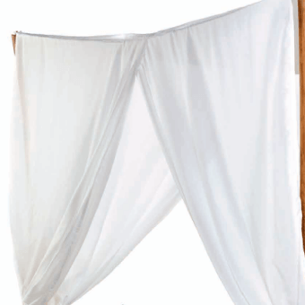 Sheer white curtains with draped fabric hang from a natural wood beam, creating symmetrical panels and a soft, translucent effect with visible grain.