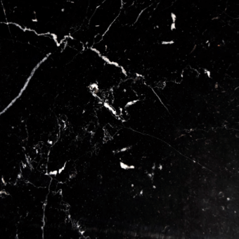 Nero marquinia marble texture with dense white veining against black, polished finish displaying fractured lines and organic crystalline patterns.