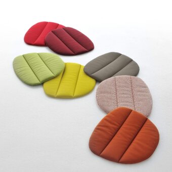 Flow armchair cushions, fabric upholstery, segmented petal shape, red, burgundy, green, yellow, gray, orange, herringbone texture.