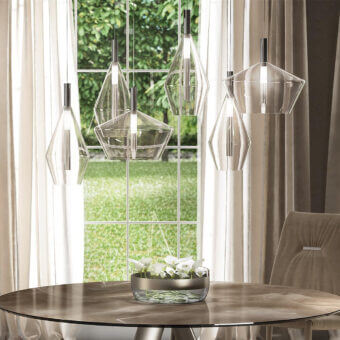 Exceptional Reflex 24 Gradi suspension lamp crafted in transparent blown glass and polished steel exhibiting luminous design
