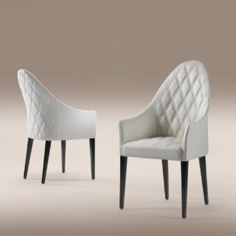 Exceptional Reflex Peggy armchair with white synthetic fabric upholstery and diamond quiltings in lacquered nero beluga wood legs