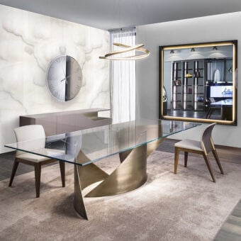 Elegant Reflex Vele table with a wide tempered glass top and curved brass metal base crafted with polished edges