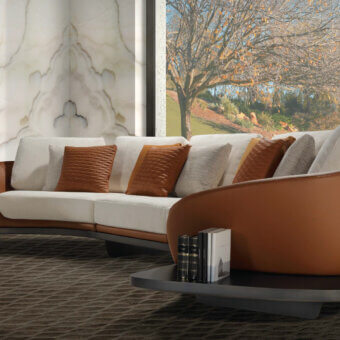 Distinctive Reflex Segno sofa with curved silhouette upholstered in light cream textile and bronze finished metal legs built with Canaletto Walnut