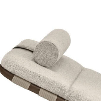 Beige roll cushion on light beige chaise lounge cushion with brown trim, white background, textured fabric, cylindrical shape.
