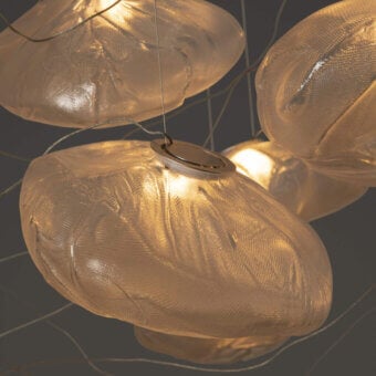 Exceptional Bocci 73 suspension lamp with hand-blown glass pendants nestled in folded ceramic vessels offering warm golden translucent shades