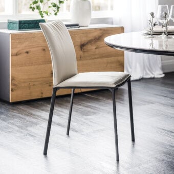 Sophisticated Cattelan Italia Rita chair with graphite painted steel frame and light beige synthetic leather upholstery