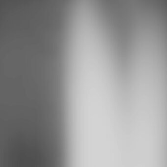 Grayscale gradient background transitions from dark gray to white, featuring a smooth, diffused texture and even lighting with blurred edges.