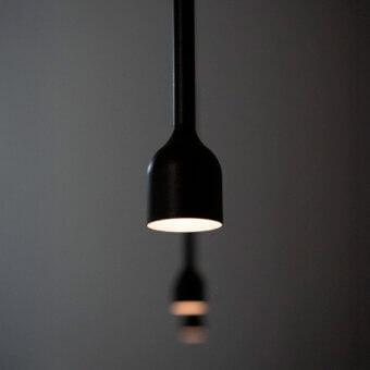 Exceptional Penta Hail suspension lamp crafted in metal with a smooth matte black finish offering focused illumination