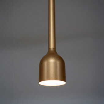 Superior Penta Hail suspension lamp crafted in metal with a warm golden satin finish and a curved silhouette