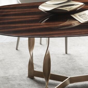 Elegant Rugiano Pliet table with dark brown wood tabletop and radiant chrome twisted metal base