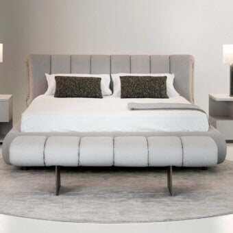 Superior Rugiano Snake bench with plush padded structure upholstered in light gray textile and sleek dark metal legs