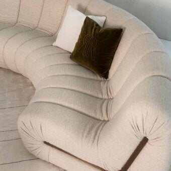 Captivating Rugiano Snake sectional upholstered in textured light beige textile with a dark accent element