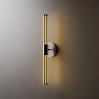 Venicem wall lamp, matte black finish, with amber glass tubes and brushed brass caps, mounted on a gradient brown-taupe wall.