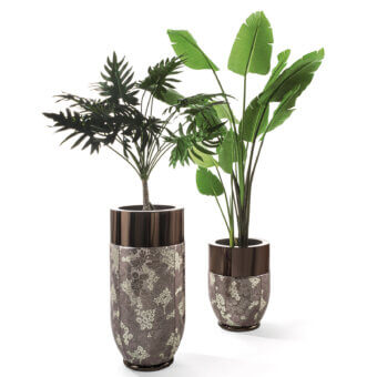 Cylindrical planters with dark brown rims display beige and olive floral patterns, holding artificial palm and banana leaf plants against white.