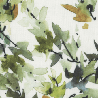 Watercolor leaf pattern with green and yellow foliage on off-white woven texture, featuring delicate branches and subtle “fiori lime” text.