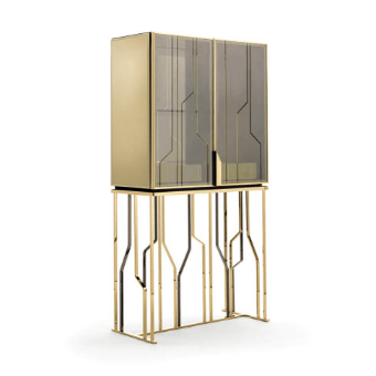 Gold bar cabinet with smoked glass doors and geometric metal base, studio product shot against a white backdrop.