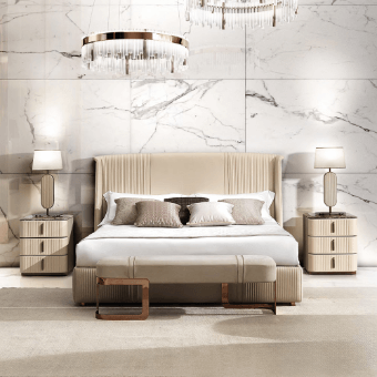 Bedroom with king bed, beige upholstered headboard, light wood nightstands, brass hardware, marble tiles, crystal chandelier, soft lighting.
