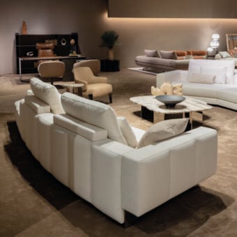 Distinguished Arketipo Milky Way sofa with gently rounded cushions upholstered in textured off-white textile and quilted vertical lines