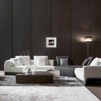 Sophisticated Bonaldo Boolean sectional with enveloping style, linear silhouette, and dark veneered wood base in light grays and browns