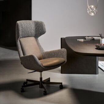 Superior Bonaldo Newton armchair upholstered in textured gray fabric with smooth brown leather and a black swivel base