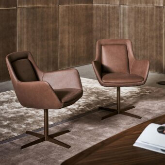 Sophisticated Bonaldo Newton armchair with enveloping brown leather and four-way swivel metal base crafted with a matte finish