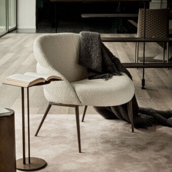 Elegant Cattelan Italia Camilla lounge chair in textured light beige fabric with dark bronze metal legs
