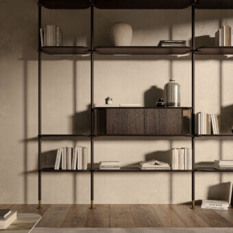 Elegant Cattelan Italia Harbour bookcase with wooden shelves, metal uprights and brass accents exhibiting a dark brown finish