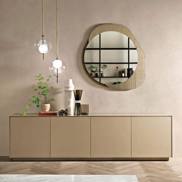 Rectangular sideboard with six doors, gold framed round mirror, and two spherical pendant lights in a minimalist interior setting.