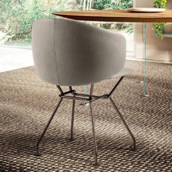 Lago Ruffle chair, light gray fabric, rounded back with puckered texture, brushed silver angled metal legs, dark brown rug setting.