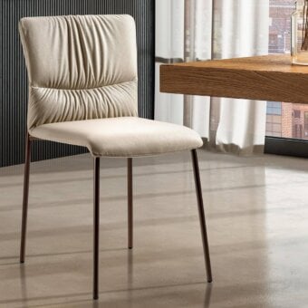 Exceptional Lago Woop chair with sinuous silhouette, plush light beige fabric upholstery and dark bronze metal legs