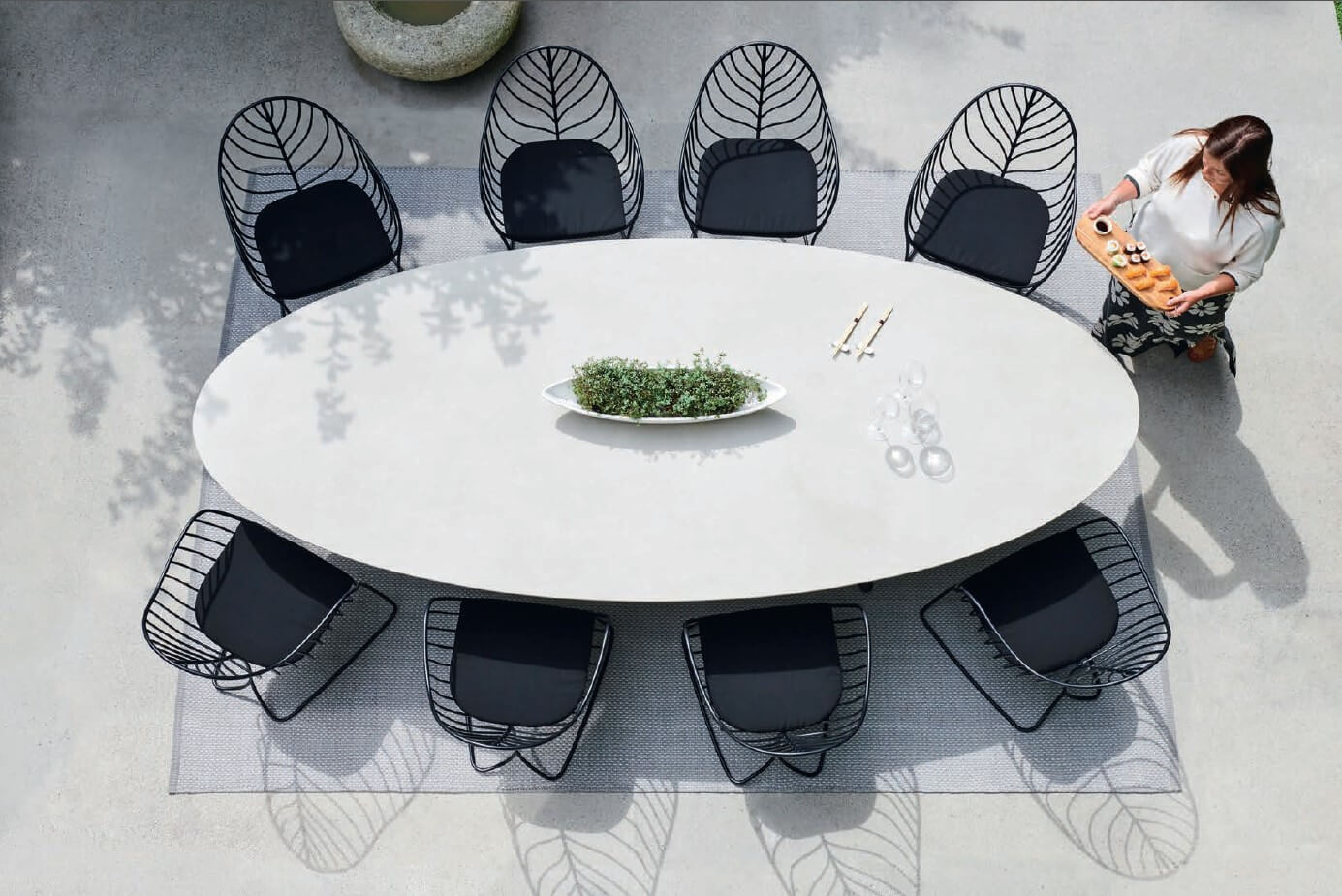 Captivating Royal Botania Folia armchair with a matte black metal frame and uniformly dark cushion embodies modern minimalist design