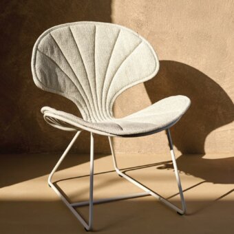 Exceptional Royal Botania Ostrea lounge chair with white coated stainless-steel structure and textured neutral cushion